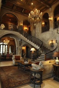 an ornate living room with chandelier and couches