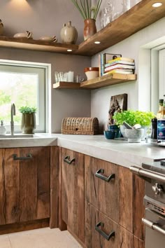 a kitchen with wooden cabinets and white counter tops next to an open window on the wall