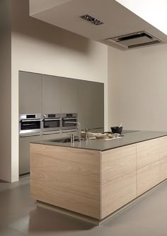 a large kitchen with an island in the middle