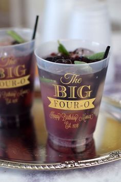 two cups filled with drinks sitting on top of a metal tray