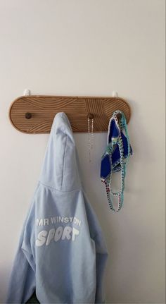 a pair of shoes hanging on a wall next to a coat rack and towel holder