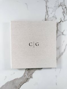 a white box sitting on top of a marble counter with the word clg written in black