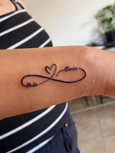 a woman's arm with a tattoo on it that says love and an infinite heart