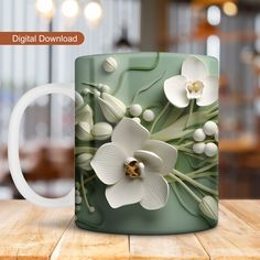 a coffee mug with flowers on it sitting on a table