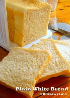 three slices of white bread sitting on top of a cutting board