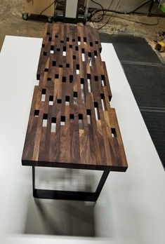 a wooden table sitting on top of a white surface