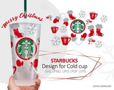 the starbucks cup is being held up by someone's hand with christmas decorations around it