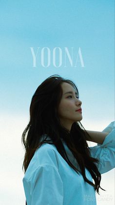 a woman standing in front of a blue sky with the words yona on it