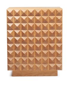 a wooden block that has been carved into the shape of pyramids