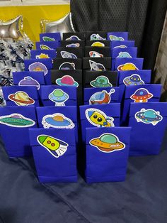 there are many bags that have space stickers on them, all in different shapes and sizes