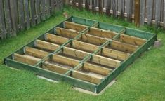 an outdoor garden area with raised wooden planters