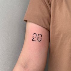 a person with a tattoo on their arm that reads 20 and has the number twenty