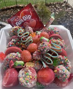 a box filled with lots of candy covered in sprinkles