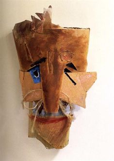 a wooden mask hanging on the wall