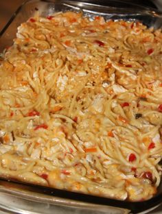 a casserole dish filled with noodles and sauce on top of a metal pan