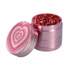 an open pink tin with hearts on it