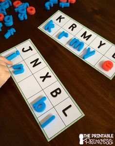 two children are playing with letters and numbers on the table, while one child is placing them