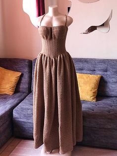 a mannequin is dressed up in a brown dress