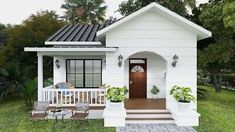 a small white house sitting on top of a lush green field