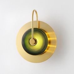 a round object with a metal handle on the side and a yellow circle around it