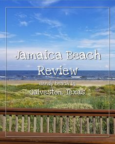 a wooden bench sitting on top of a sandy beach