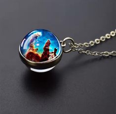 a glass ball necklace with an image of the star wars scene inside it on a chain