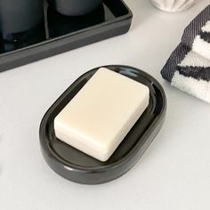 a black and white tray with soap on it