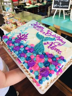 a decorated sheet cake sitting on top of a table