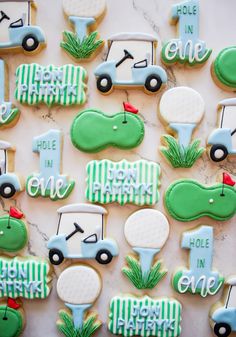 decorated cookies are arranged on a table for a golf themed birthday party or baby shower