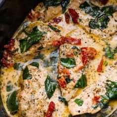 chicken with spinach and tomato sauce in a skillet