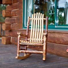 a wooden rocking chair sitting on top of a porch