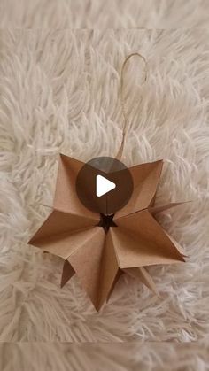 an origami star hanging on a white rug