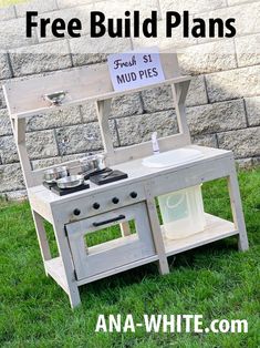 an old wooden stove sitting in the grass with a sign on it that says free build plans