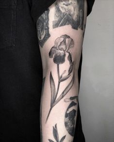 a person with a tattoo on their arm has a flower in the middle of his arm