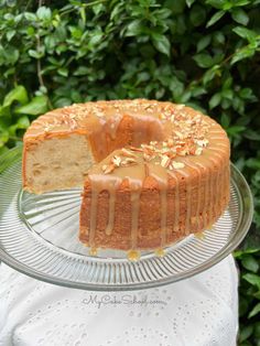 a bundt cake on a glass platter with a slice cut out