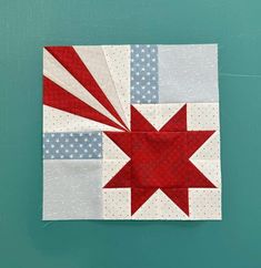 a red, white and blue patchwork quilt with an american flag design on it