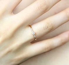 a woman's hand with a diamond ring on it