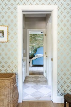 an entry way leading to a bedroom with a blue chair