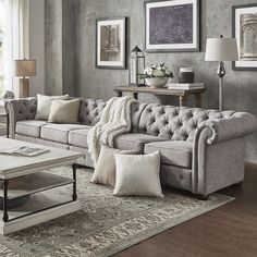 a living room filled with furniture and pillows on top of a carpeted floor next to a window