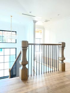 an empty room with wooden floors and railings