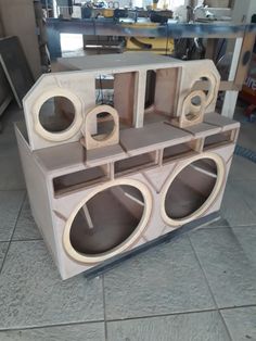 an unfinished speaker cabinet sitting on the floor