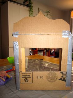 an empty cardboard box sitting on top of a table