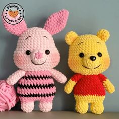 two crocheted winnie the pooh and piglet stuffed animals sitting next to each other