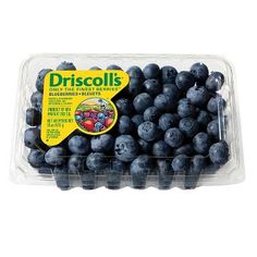 a plastic container filled with blueberries on top of a white surface