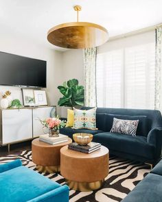 a living room filled with furniture and a flat screen tv mounted to the side of a wall