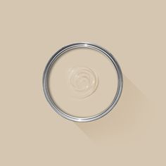 a white paint can with a light brown background