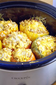 an open crock pot filled with stuffed peppers