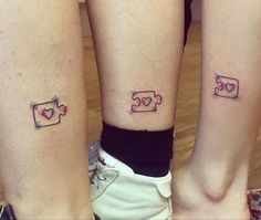 two people with matching tattoos on their legs, both have puzzle pieces in the shape of hearts