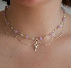 This celestial-inspired piece is a must-have for those looking to add a touch of elegance to your jewellery collection. The centrepiece of this stunning necklace is a radiant silver sun/star pendant adorned with pastel purple and white beads. It also showcases a handcrafted arrangement of delicate chain layers, each contributing to its intricate and delicate aesthetic. Whether you're attending a special event, enjoying a romantic evening, or simply adding a touch of celestial elegance to your everyday style, this necklace will be your go-to accessory. With its timeless beauty and versatility, this necklace makes a perfect gift for yourself or a loved one. The delicate silver chains gracefully cascade, creating a subtle and ethereal look that complements both casual and formal attire. Versa Purple Star Necklace, Chain And Bead Necklace, Dainty Beaded Necklaces, Beaded Necklace Inspiration, How To Make Beaded Necklaces, Beads Necklace Ideas, Beaded Necklace Ideas, Collar Aesthetic, Delicate Aesthetic