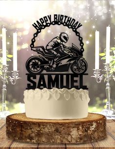 a birthday cake with a motorcycle on it and candles in front of the cake, which reads happy birthday samuel